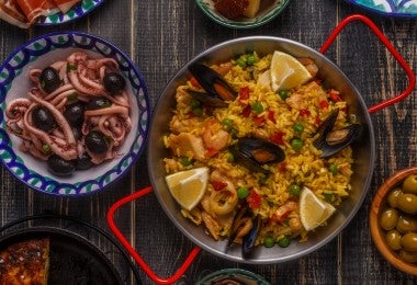 Mesa llena de distintos tipos de calamar y preparaciones de este ingrediente marino.